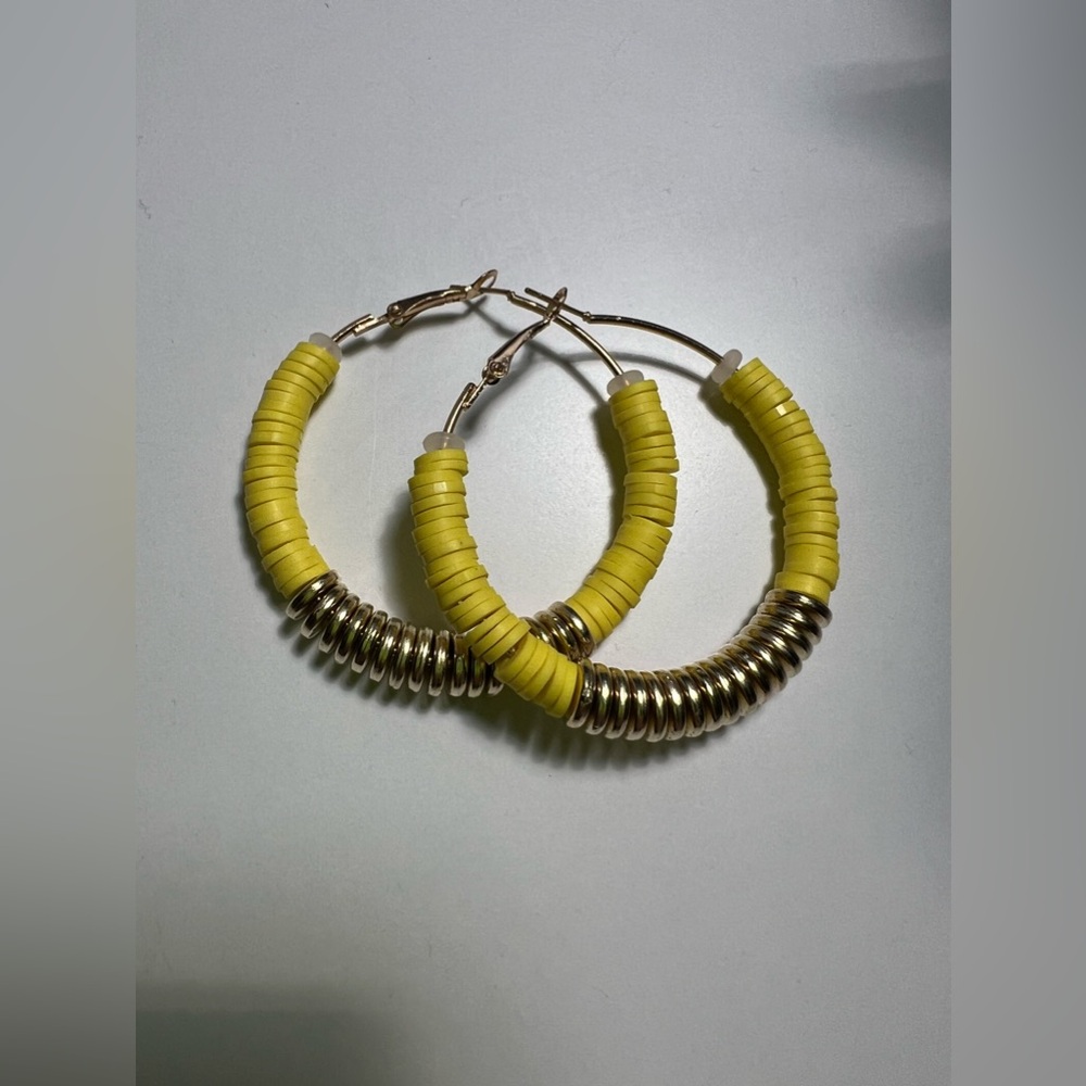 Bright yellow hoop earrings.